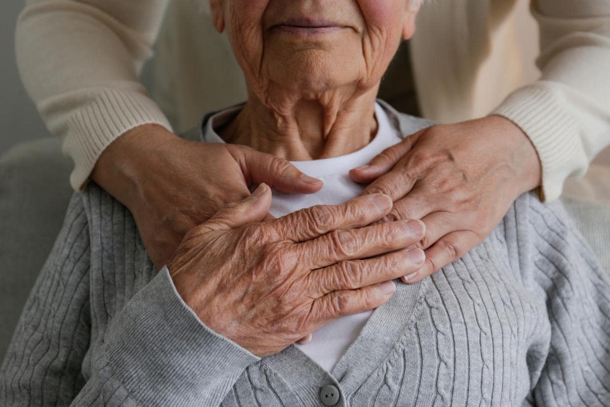 Senior Home Care Caregiver helping old lady with a cane