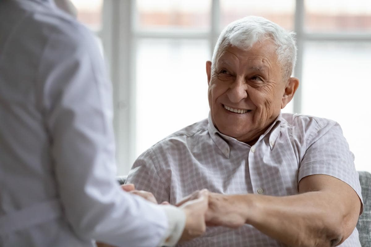 Senior Home Care Caregiver helping old lady with a cane